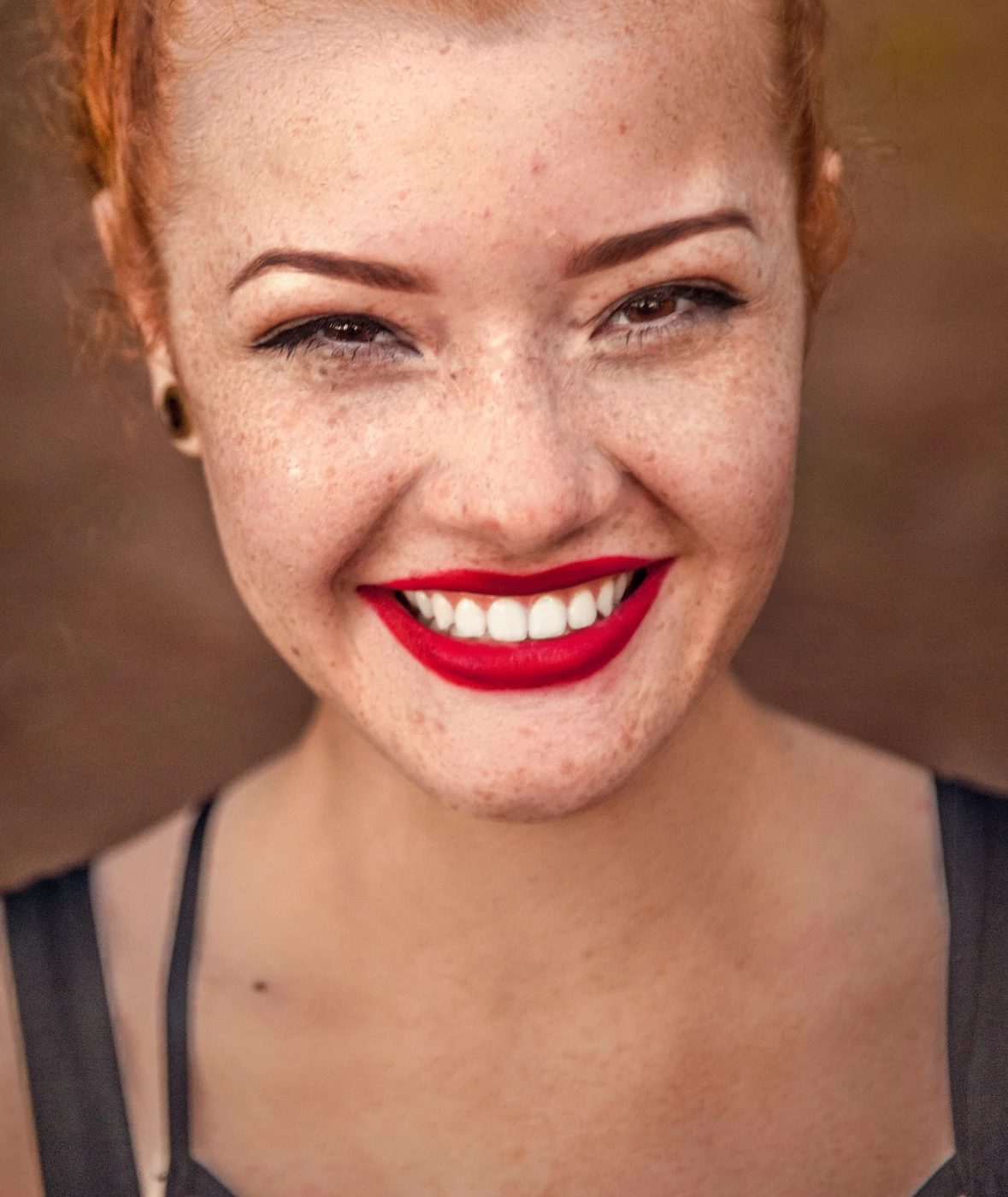 Freckles kept, skin evened, smile brightened (default settings) — after