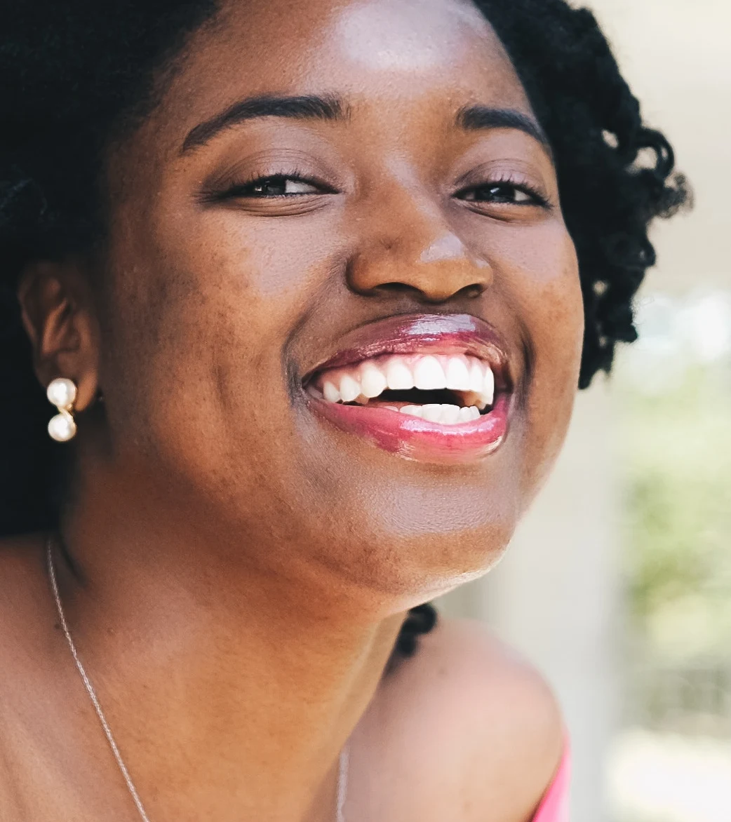 Dark spots softened, smile and texture kept (default settings) — after