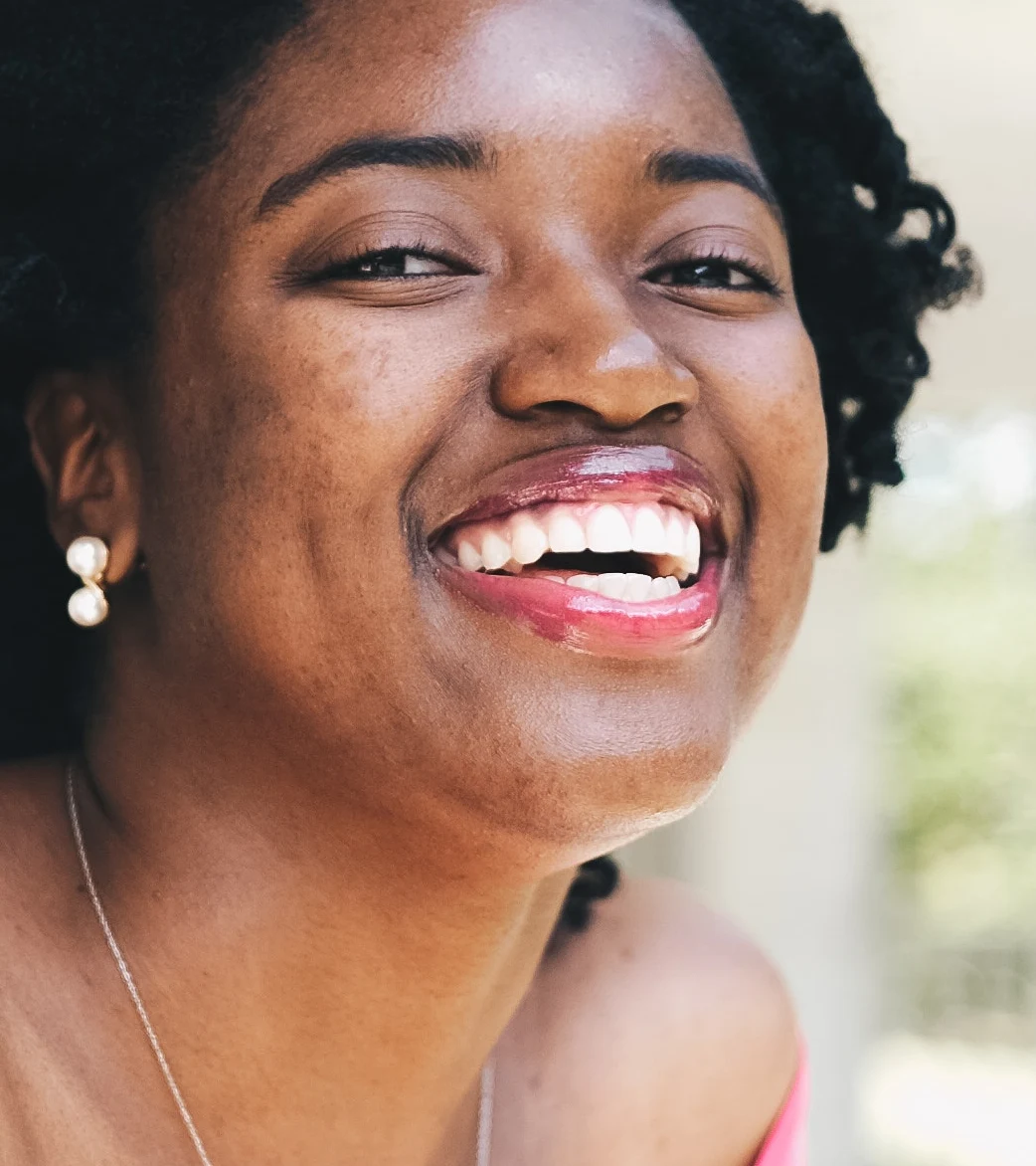 Dark spots softened, smile and texture kept (default settings) — before